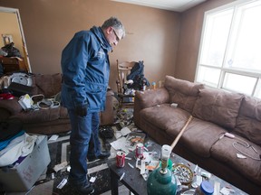Bylaw enforcement manager Orest Katolyk stands amid the filth in a unit of an apartment building at 1438 Beckworth Ave. in London. The building has been boarded up pending a massive cleanup. (DEREK RUTTAN, The London Free Press)