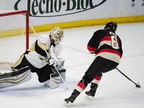Feb 12, 2015; Ottawa, Ontario, CAN; Pittsburgh Penguins goalie Thomas Greiss (1) blocks the shot from Ottawa Senators right wing Bobby Ryan (6). The Penguins defeated the Senators 5-4 in a shootout at the Canadian Tire Centre. Mandatory Credit: Marc DesRosiers-USA TODAY Sports