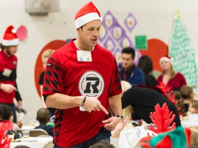 Ottawa REDBLACKS Kevin Scott was on hand to serve lunch and spend time with children at St. Elizabeth School on Tuesday December 16, 2014.