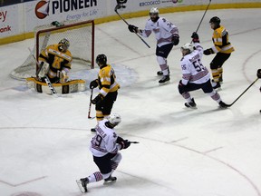 Oshawa Generals Cole Cassels, Michael McCarron and Hunter Smith (34) celebrate Cassels’ power-play goal against Frontenacs goalie Jeremy Helvig as Kingston defencemen Nathan Billitier (6) and Chad Duchesne look on during OHL action at the Rogers K-Rock Centre on Friday night. The Generals won 7-1. (Steph Crosier/The Whig-Standard)