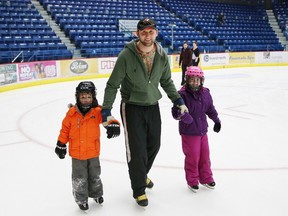 JOHN LAPPA/THE SUDBURY STAR
Mike Mills skates with his children, Jasmine 7, left, and Nicholas, 6, at the Sudbury Community Arena during public skating last year.