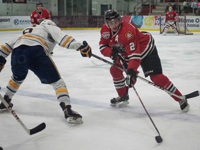 Karl El-Mir, Grande Prairie Storm forward, tries to grab the puck from James Vermeulen, Whitecourt Wolverines defense, during an AJHL game at the Scott Safety Centre on Friday February 13, 2015 in Whitecourt, Alta. The Wolverines defeated the Storm 4-2 ending Grande Prairie's playoff hopes. Adam Dietrich/Whitecourt Star/QMI Agency