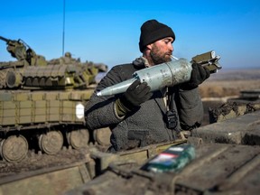 A Ukrainian serviceman loads ammunition into a tank in the territory controlled by Ukraine's government forces, Donetsk region Feb. 13, 2015. REUTERS/Alexei Chernyshev