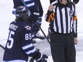 Referee Tom Kowal tells Winnipeg Jets centre Mathieu Perreault to get to the penalty box as Perrault argues an interference minor he took against the Philadelphia Flyers during NHL action at MTS Centre in Winnipeg, Man., on Sun., Dec. 21, 2014.