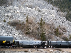 Two tank cars loaded with crude oil lay on their side after a Saturday morning derailment in Crowsnest Pass, Alta. A total of 12 cars left the tracks just after 4:30 a.m. on Saturday, Feb. 14 from a westbound freight train passing through the Frank Slide. An official with Canadian Pacific said the cars remained intact, and no oil leaked from the cars. Nobody was injured in the derailment, and there was no risk to the public. The cause of the derailment is under investigation. Greg Cowan/QMI Agency