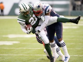 Jets running back Chris Johnson (front) is tackled by Patriots cornerback Darrelle Revis during NFL action in East Rutherford, N.J., on Dec. 21, 2014. (Robert Deutsch/USA TODAY Sports)