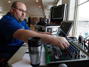 Volunteer DJ Jamie Edgar from Mr. Entertainment plays tunes that broadcast over the site at The World's Longest Hockey at Saiker's acres east of Sherwood Park  on Tuesday February 10, 2015. Tom Braid/Edmonton Sun/QMI Agency