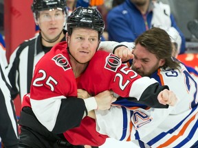 Edmonton Oilers left wing Luke Gazdic (20) fights with Ottawa Senators right wing Chris Neil (25) in the second period at the Canadian Tire Centre. Mandatory Credit: Marc DesRosiers-USA TODAY Sports