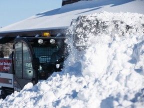 Snow is cleared with a Bobcat Toolcat after an overnight dump of snow during the 25th annual Silver Skate Festival at Hawrelak Park in Edmonton, Alta., on Saturday, Feb. 14, 2014. The festival runs from Feb. 13-22. The official kickoff was held on Feb. 14. Ian Kucerak/Edmonton Sun/ QMI Agency