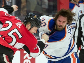 Feb 14, 2015; Ottawa, Ontario, CAN; Edmonton Oilers left wing Luke Gazdic (20) fights with Ottawa Senators right wing Chris Neil (25) in the second period at the Canadian Tire Centre. Mandatory Credit: Marc DesRosiers-USA TODAY Sports
