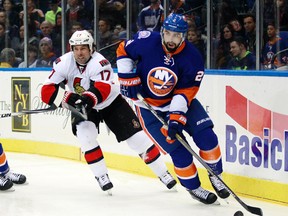 New York Islanders defenseman Nick Leddy (2) plays the puck while being pursued by Ottawa Senators center David Legwand (17) during the first period at Nassau Veterans Memorial Coliseum. Mandatory Credit: Andy Marlin-USA TODAY Sports