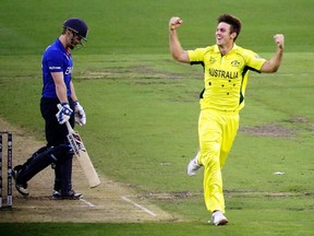 Australia’s Mitchell Marsh (right) celebrates after dismissing England captain Eoin Morgan yesterday at the Cricket World Cup. (Reuters)