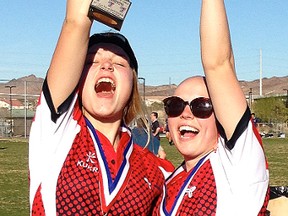 Tia Svoboda (left) of Belleville hoists the Open Girls high school trophy with teammate Olivia Apps of Lindsay following Team Ontario's victory at the Las Vegas Invitational Sevens rugby tournament Friday. (Submitted photo)