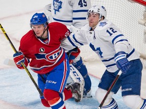 The Canadiens’ Christian Thomas battles with Maple Leafs defenceman Stephane Robidas during the second period in Montreal on Saturday night. (Johany Jutras/QMI Agency)