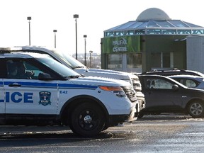 Police cars are seen outside the Halifax Shopping Centre, which was named by police as the intended target of an attack which they said was thwarted in Halifax, Nova Scotia Feb. 14, 2015. REUTERS/Darren Pittman