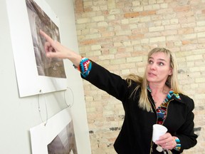 Lawyer Sharon Hassan shows photographs of what the building looked like before a major renovation at Hassan Law on Dundas Street in London, Ontario on Thursday February 12, 2015.  Hassan Law, which is housed in the 150 year old Chisholm Building on Dundas Street, is one of ten London Heritage Awards Honourees
CRAIG GLOVER/The London Free Press/QMI Agency