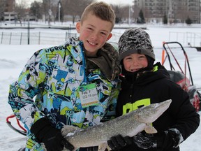 Petrolia brothers Drake and Darius Landon show off a large pike they caught in the Sarnia Bay Saturday. Plenty of families took advantage of Ontario's license-fee fishing event this Family Day weekend. BARBARA SIMPSON/THE OBSERVER/QMI AGENCY
