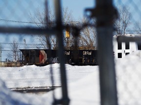 A Canadian Pacific Railway car is seen through a locked fence as it sits in their yard in Montreal Feb. 15, 2015. REUTERS/Christinne Muschi