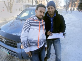 Seid Ahmed (right) is a driving instructor in Winnipeg, he specializes in teaching new Canadians how to drive in Manitoba.  Abdifatah H. Abdillahi is one of his students.  Friday, February  13, 2015. (Chris Procaylo/Winnipeg Sun/QMI Agency)