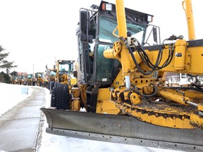 A line of graders parks on the service road along 50 Street and 92 Avenue in Edmonton, Alberta on Saturday Feb.14, 2015. Perry Mah/Edmonton Sun/QMI Agency