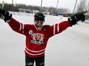 Event organizer Brent Saik celebrates the good weather on ice at the World's Longest Hockey Game at Sherwood Park, Alberta on Sunday Feb.15, 2015.  Perry Mah/Edmonton Sun/QMI Agency