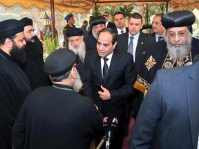 Egyptian President Abdel Fattah al-Sisi (C) arrives to meet with Coptic Pope Tawadros II (R), to mourn for the Egyptians beheaded in Libya, at Saint Mark's Coptic Orthodox Cathedral in Cairo, in this Feb. 16, 2015 handout picture courtesy of the Egyptian Presidency. REUTERS/The Egyptian Presidency/Handout via Reuters