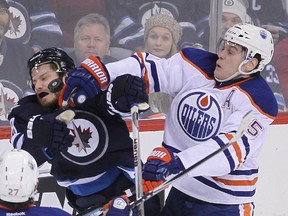 Winnipeg's Brian Little and Oilers defenceman Mark Fanye tangle during Monday's NHL game in Winnipeg (Brian Donogh, QMI Agency).