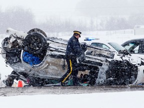 Emergency crews work at the scene of a fatal single vehicle crash along the QEII Hwy. south of Edmonton on Monday Feb. 16, 2015. (David Bloom/Edmonton Sun)