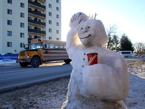 A snow figure holds a Tim Hortons cup as it waves to passing vehicles on John Counter Boulevard, just west of Montreal Street in Kingston, Ont., on Tuesday January 20, 2015. (Ian MacAlpine/QMI Agency)