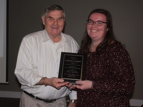 Chatham-Kent GFO president Joe Vanek presents Blenheim 4-H Field Crop Club member Stephanie Campbell an award for submitting the top wheat sample at the 2014 Royal Agricultural Winter Fair.