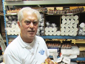 Gus Pantazis, owner of Global Donuts and Deli, on London Road in Sarnia, holds a tray of paczkis waiting Tuesday morning to make their way from the kitchen to a steady stream of customers arriving out front. Trays of the Polish pre-Lenten treat were sitting on every available shelf in the kitchen and storeroom, as well as some makeshift ones, where it was all hands on deck as staff worked to keep up with demand. PAUL MORDEN /THE OBSERVER/QMI AGENCY