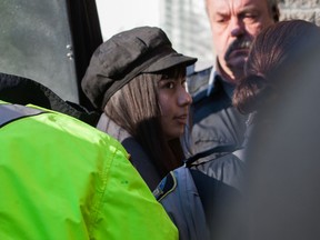 Lindsay Souvannarath, 23, from Geneva, Ill., is escorted out of Halifax court on Tuesday Feb. 17, 2015. Souvannarath, along with 20-year-old Randall Shepherd, of Cole Harbour, N.S., have been charged by RCMP in an alleged mass murder plot at a Halifax mall. (Scott Blackburn/QMI Agency)