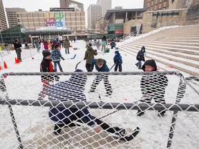 Dean McDonald plays goalie as kids play hockey during Family Day at Churchill Square in Edmonton, Alta., on Monday, Feb. 16, 2015. Family Day events were held across the city. Ian Kucerak/Edmonton Sun/ QMI Agency