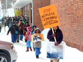 Protestors march down Park Street on their way to hold a rally against the Energy East Pipeline in front of the Kenora Shoppers Mall on Monday, Feb. 16.