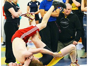 Quinte's Jesse Elliott (red shorts) and Trenton's Logan Thurston put on a spirited show in their boys 61-kilogram final at last week's Bay of Quinte wrestling championships in Rick Locke Gym at Quinte S.S. Elliott won, 13-12. (Catherine Frost for The Intelligencer)