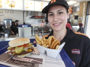 Cheyanna displays a burger, fries and onion rings at a Harvey's in Winnipeg, May 24, 2012.  (QMI Agency files)