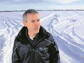 Luke Hendry/The Intelligencer
Quinte Conservation's Bryon Keene stands on the shore of the frozen Bay of Quinte in Belleville Tuesday. The conservation authority says ice on rivers, however, may be unstable, even when it appears safe.