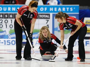Ontario skip Julie Hastings (centre) delivers her shot with lead Katrina Collins (left) and second Stacey Smith (right) in their game against British Columbia during the Scotties Tournament of Hearts in Moose Jaw, Sask., on Tuesday, Feb. 17, 2015. (Todd Korol/Reuters)