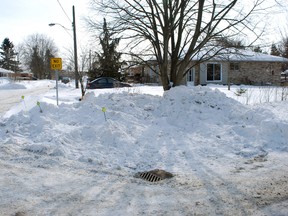 This mound of snow at the corner of Chester and Willow streets in St. Thomas has a long-time resident voicing concerns about safety and potential damage to the property. (Ben Forrest, Times-Journal)