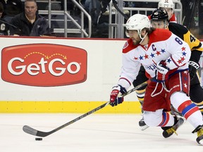 Capitals left wing Alex Ovechkin skates with the puck ahead of Penguins centre Maxim Lapierre (40) during the first period NHL action in Pittsburgh on Tuesday, Feb. 17, 2015. (Charles LeClaire/USA TODAY Sports)