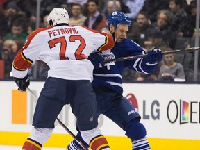New Maple Leaf Olli Jokinen gets hit by Alex Petrovic of Florida Panthers during action at the Air Canada Centre last night. It was Jokinen’s first game as a member of the blue and white. (Craig Robertson/Toronto Sun)