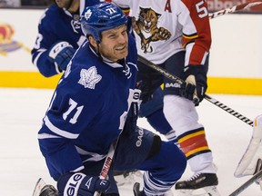 David Clarkson of the Toronto Maple Leafs grimaces after taking a shot in the leg  in front of Roberto Luongo  of Florida Panthers at the Air Canada Centre  on Tuesday (Craig Robertson/Toronto Sun/QMI Agency)
