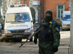 An armed Ukrainian soldier guards access to a hospital in Artemivsk, February 18, 2015. Government forces started pulling out of a town in eastern Ukraine on Wednesday after a fierce assault by Russian-backed separatists which Europe said violated a crumbling ceasefire.  REUTERS/Gleb Garanich