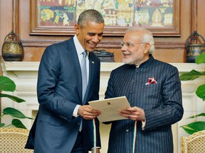 India's Prime Minister Narendra Modi (R) presents a reproduction of telegram sent by U.S. to the Indian Constituent Assembly in 1946, to U.S. President Barack Obama during their meeting in New Delhi January 25, 2015.  REUTERS/India's Press Information Bureau/Handout via Reuters