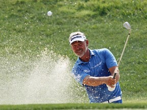 Darren Clarke of Northern Ireland chips onto the 17th green during the third day of practice for the 96th PGA Championship at Valhalla Golf Club in Louisville, Kentucky, August 6, 2014. (REUTERS)