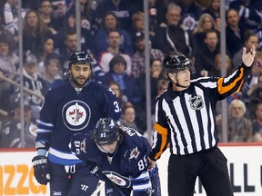 Winnipeg Jets forward Mathieu Perreault (85) reacts to an injury during the first period against the Edmonton Oilers at MTS Centre Feb. 16, 2015.