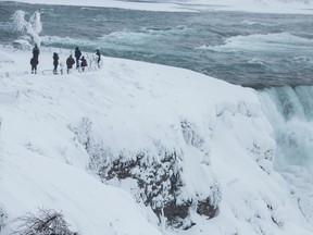 Visitors view Niagara Falls in sub freezing temperatures in Niagara Falls, N.Y., on Feb. 17, 2015. (REUTERS/Lindsay DeDario)