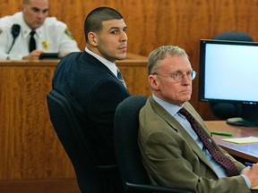 Former New England Patriots star Aaron Hernandez (left) listens to testimony with defence attorney Charles Rankin during his murder trial at the Bristol County Superior Court in Fall River, Mass., February 18, 2015. (REUTERS/Dominick Reuter/Pool)