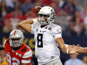 Oregon Ducks quarterback Marcus Mariota (8) throws a pass against the Ohio State Buckeyes in the 2015 National Championship Game at AT&T Stadium. (Matthew Emmons/USA TODAY Sports)