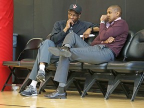 Raptors GM Masai Ujiri (right), chatting with coach Dwane Casey during a practice, will have to decide before today’s 3 p.m., NBA trade deadline if his roster needs any tweaking. (CRAIG ROBERTSON, Toronto Sun)